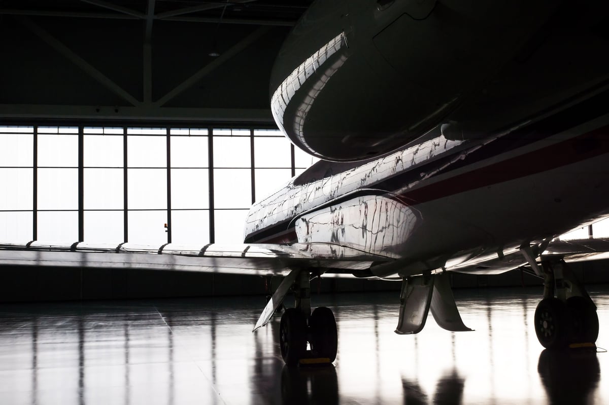 Luxurious business jet plane being stored inside the hangar
