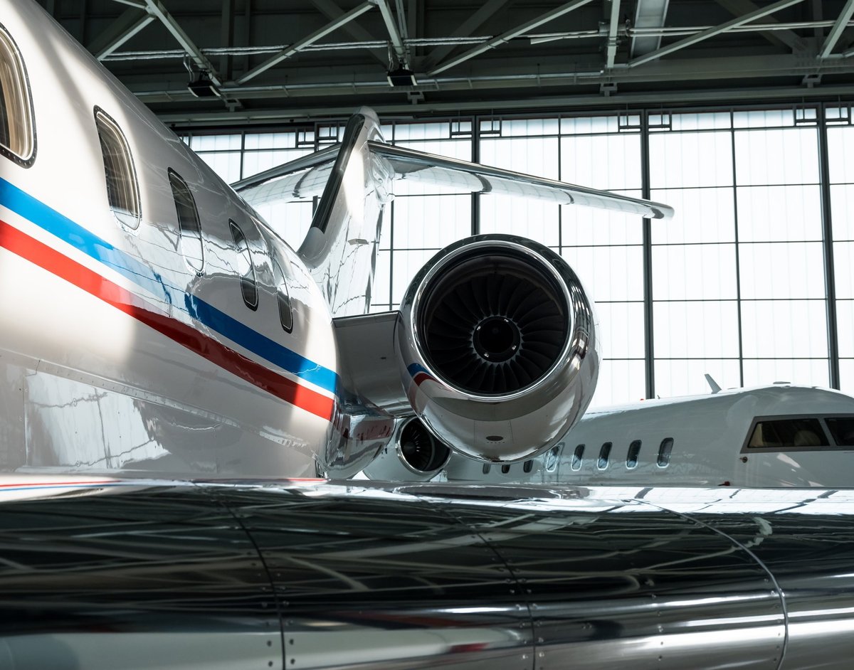 Luxurious business jet planes bombardier challenger and gulfstream being stored inside the hangar
