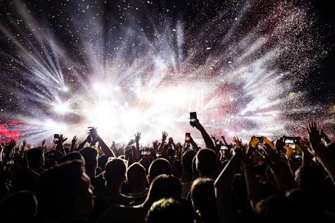 Concert crowd with confetti and fireworks at festival