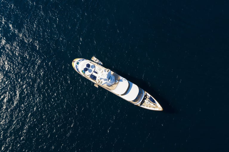 Stunning aerial view of a luxury yacht sailing on a blue sea, Emerald Coast Sardinia
