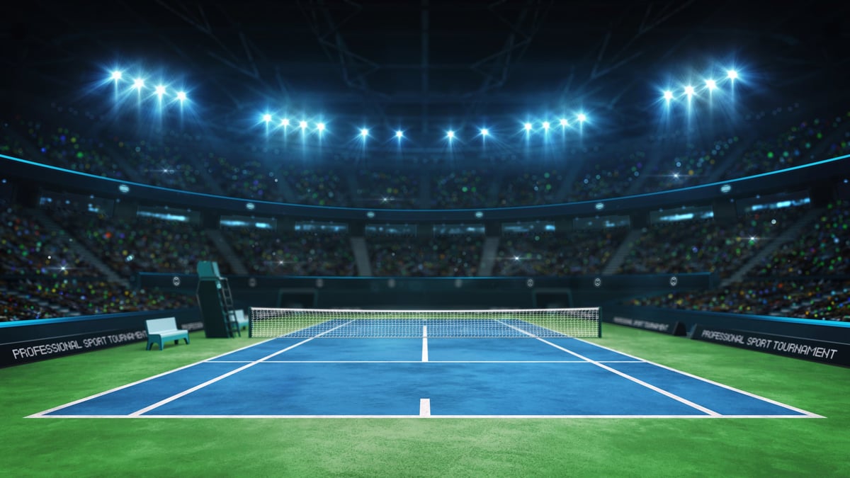 Professional tennis match at the US Open with packed stadium and dramatic lighting