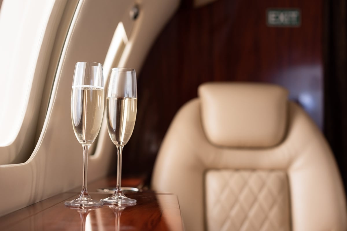 Luxury private jet interior with champagne, arriving in Melbourne