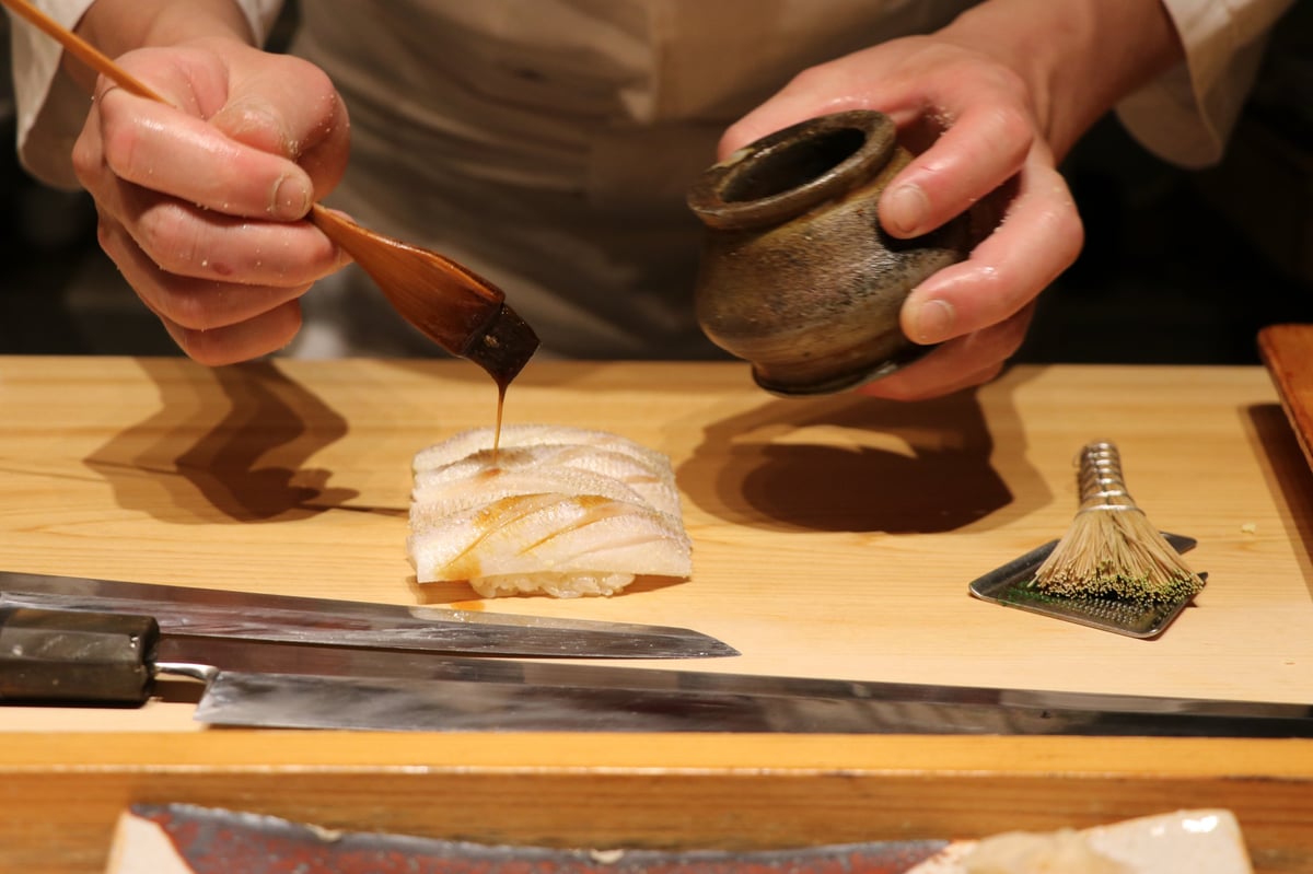 Japanese master chef preparing omakase sushi at Tokyo Michelin-starred restaurant