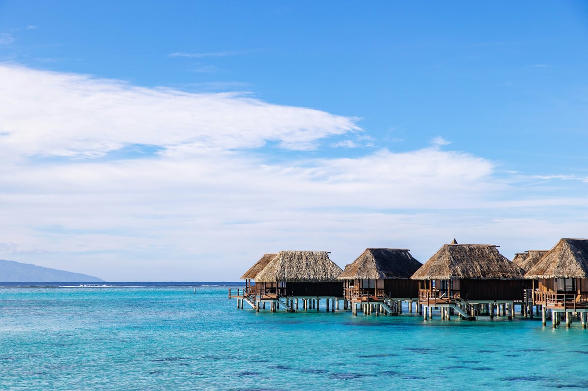 Overwater bungalows tropical island resort South Pacific