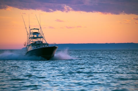 Boat cruising at sunset