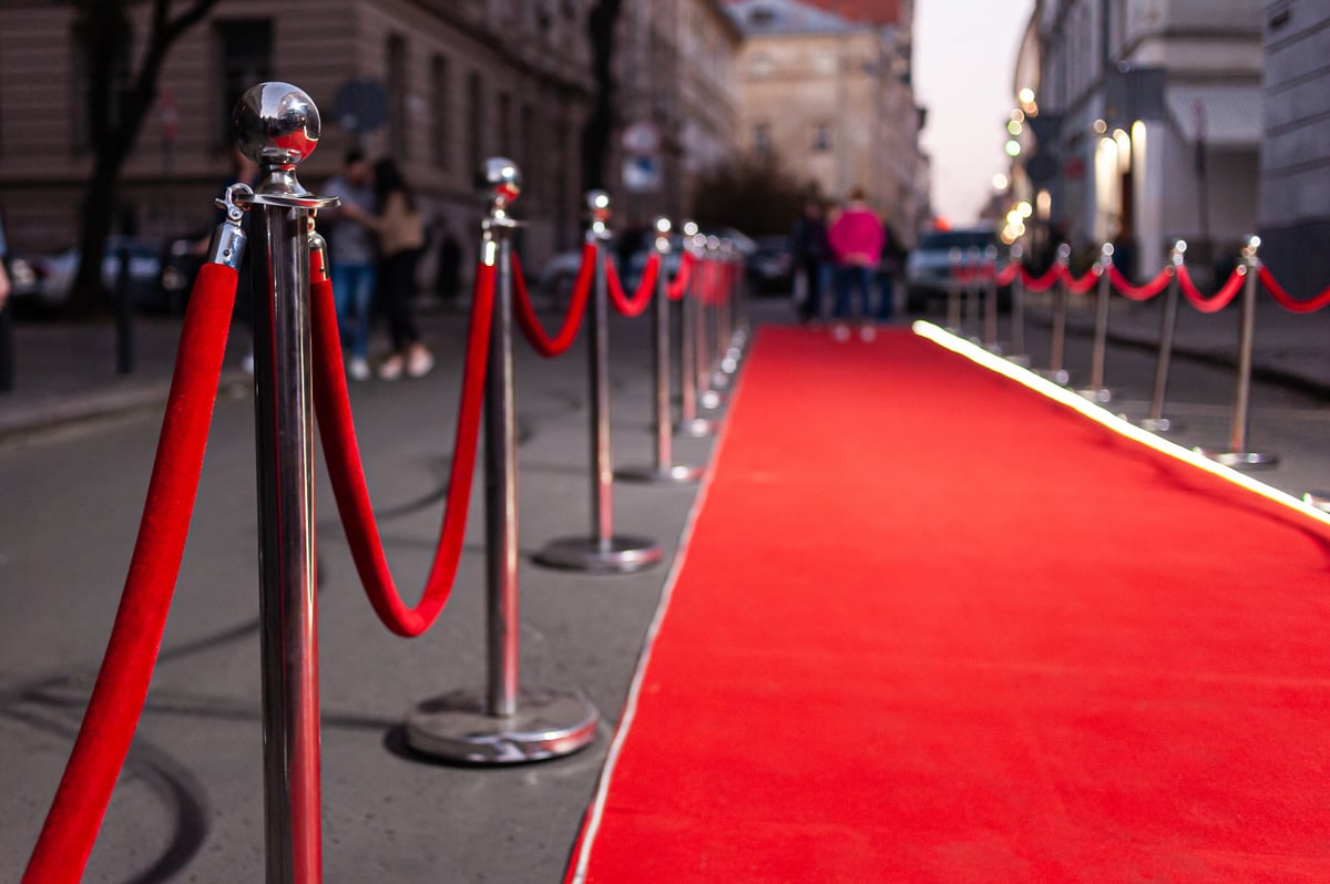 Red event carpet and gold rope barrier symbolizing success and triumph at a prestigious film festival