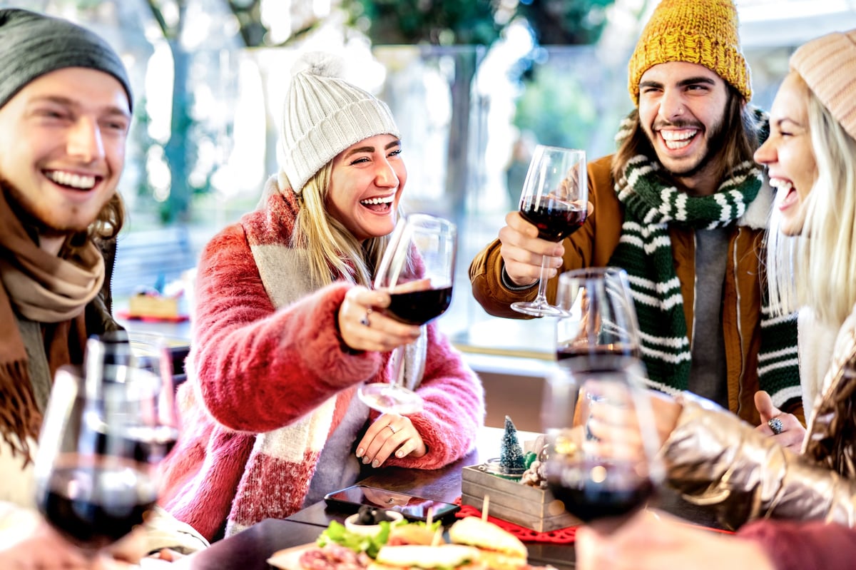 Friends enjoying après-ski drinks and champagne at a mountain bar