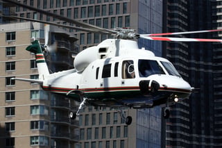 Luxury private helicopter over city