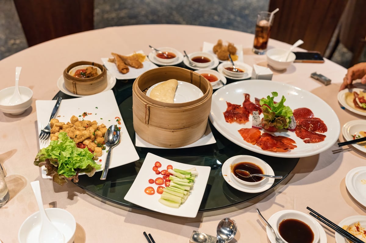 Beijing crispy skin duck with soy sauce on round table in chinese restaurant