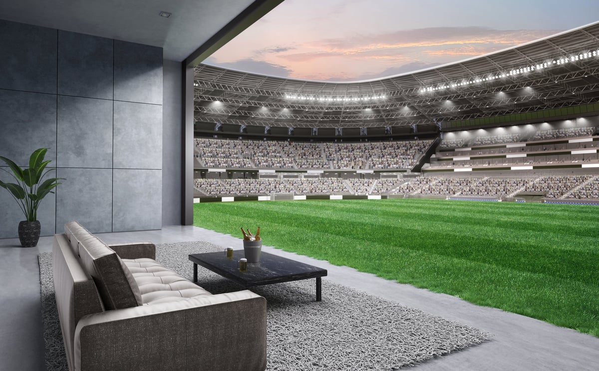 Living room with football field view through large windows