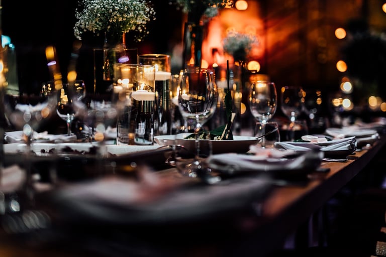 Luxury table settings for fine dining with and glassware, pouring wine to glass