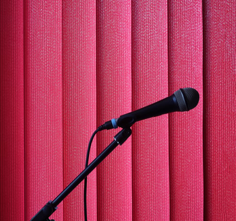 This is a microphone in front of red curtains