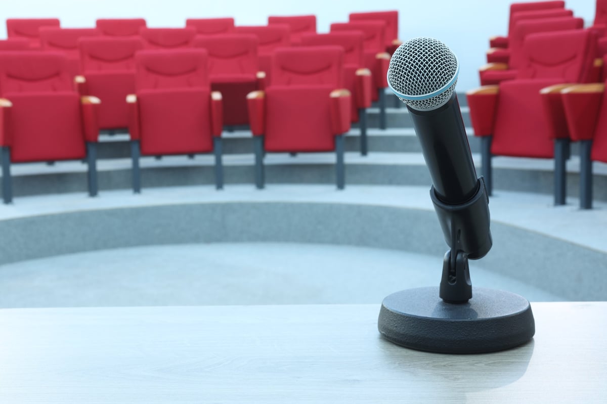 Microphone in front of empty red seats