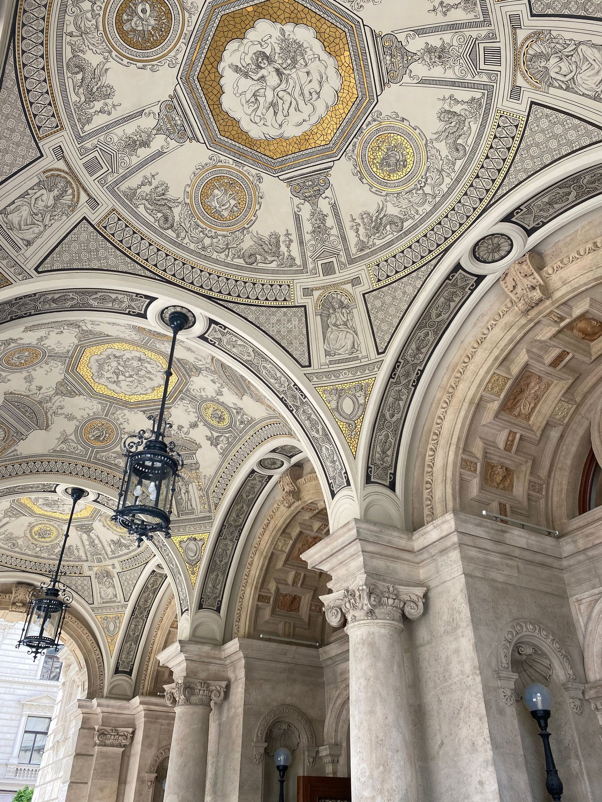 Elegant opera house interior with chandeliers and gold details