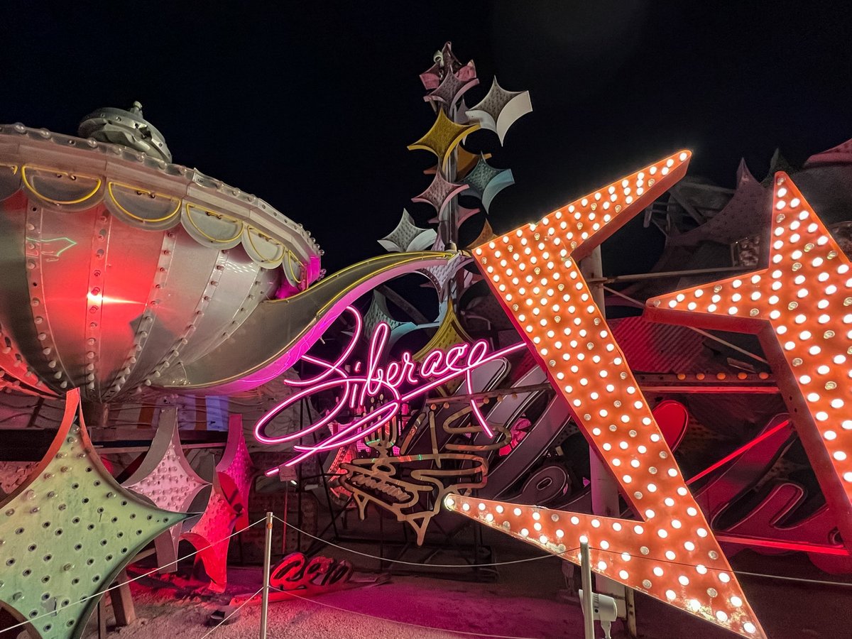 Neon signs lighted at night at The Neon Museum in Las Vegas, Nevada