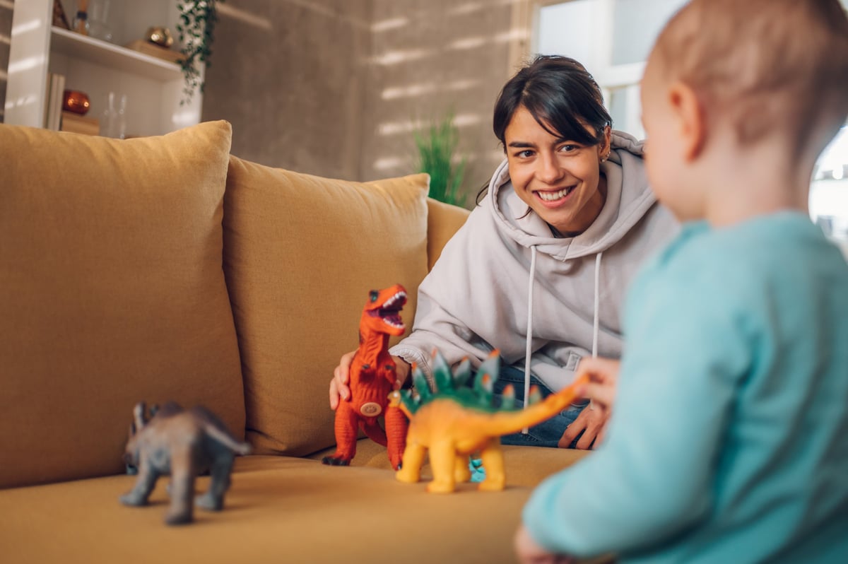 Mother and toddler playing with toys