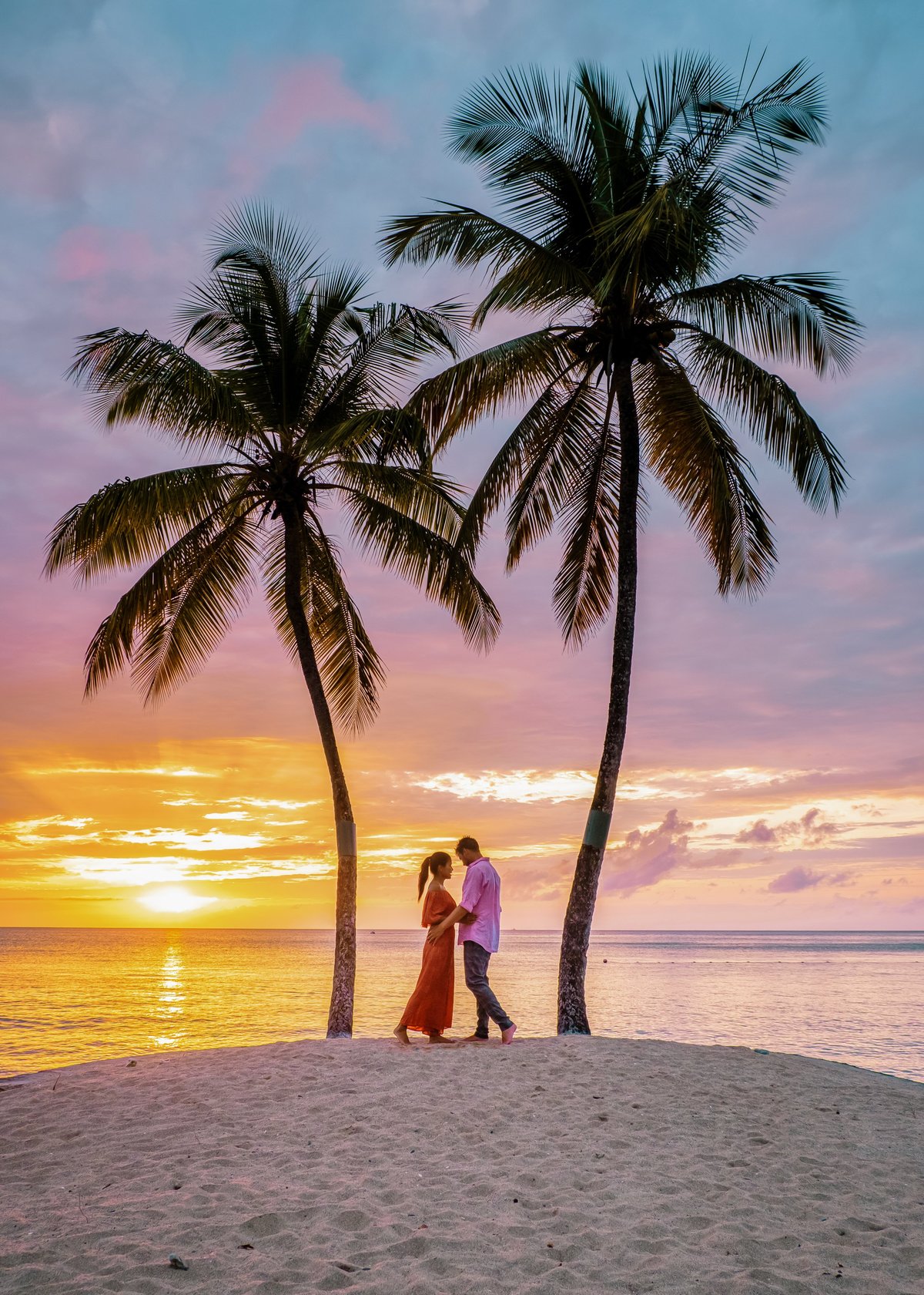 Saint Lucia Caribbean Island couple watching sunset under palm tree during vacation