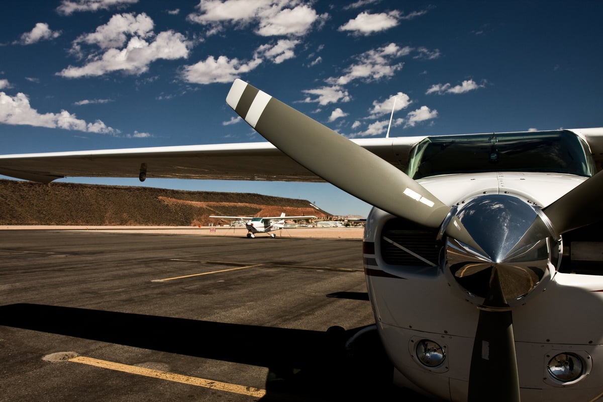 General aviation airplane on the tarmac in Utah with a blue sky and clouds in the background