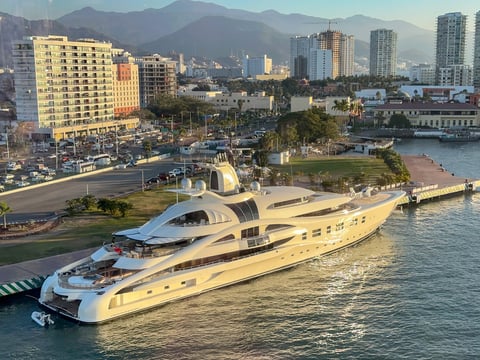 Superyacht with helicopter on deck moored in port