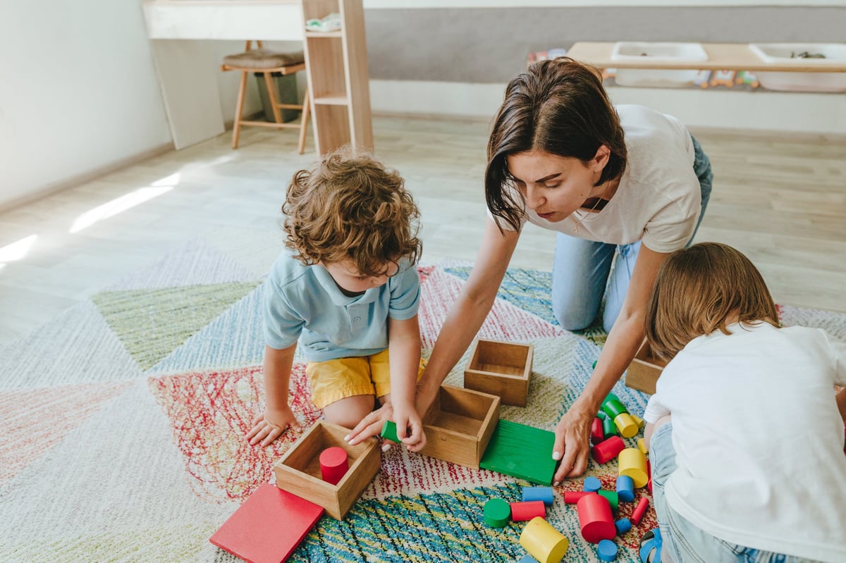 Young teacher playing with children