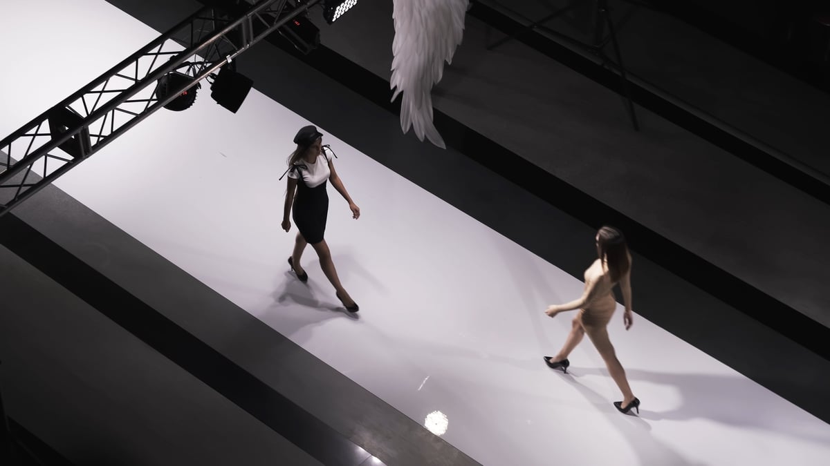 Fashion design female clothes woman on podium slow motion spotlights catwalk show