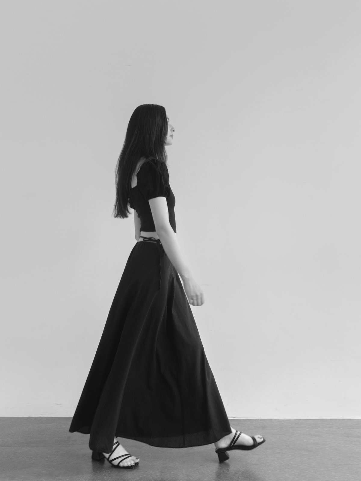 Beautiful woman wearing stylish romantic clothes Korean style aesthetic Black top and maxi skirt Minimalistic and pretty Lookbook shoot