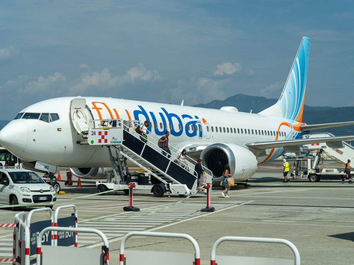 Fly Dubai Boeing 737 MAX 8 at the gate of the terminal of the BGY Milano Bergamo international airport