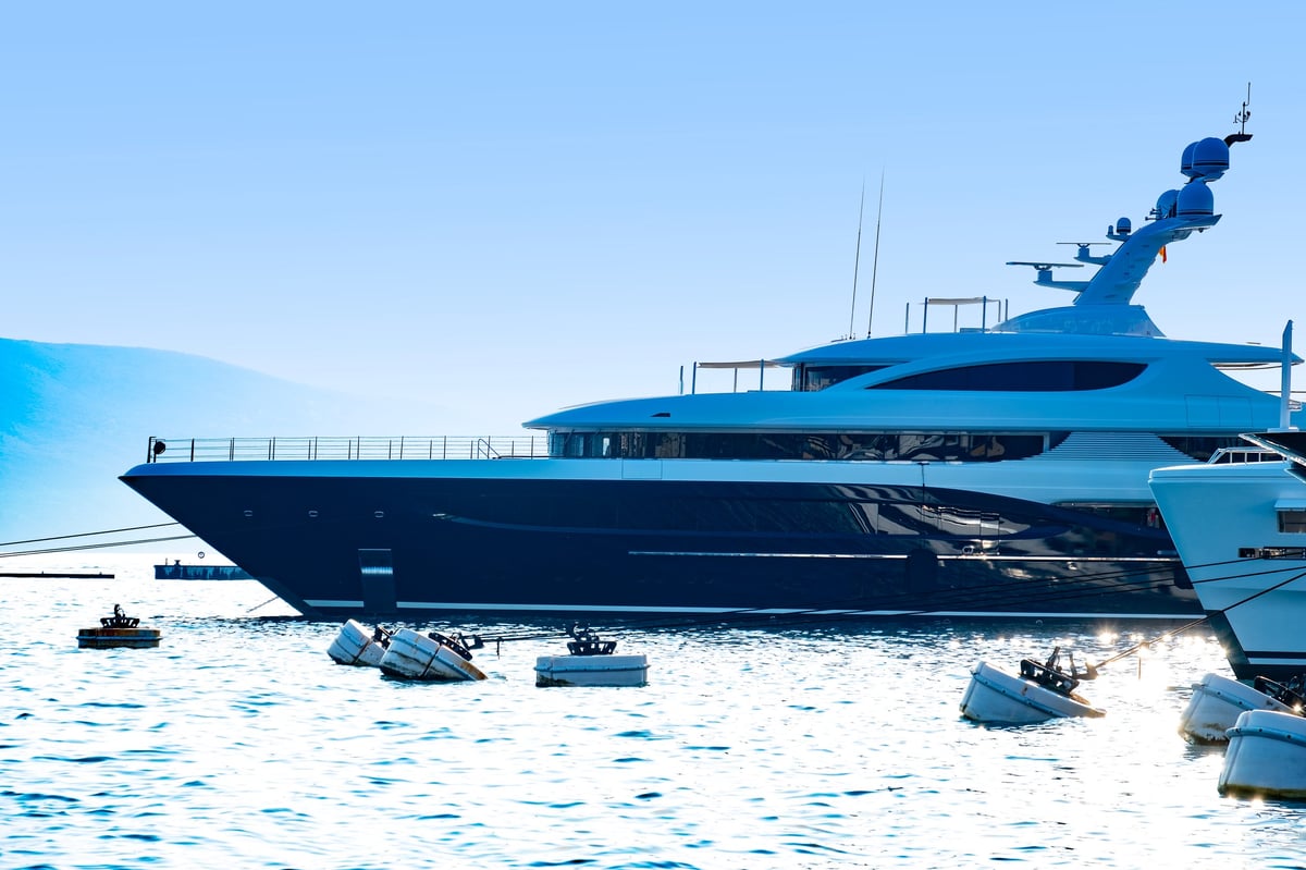 Luxury yachts lined up in coastal upscale marina
