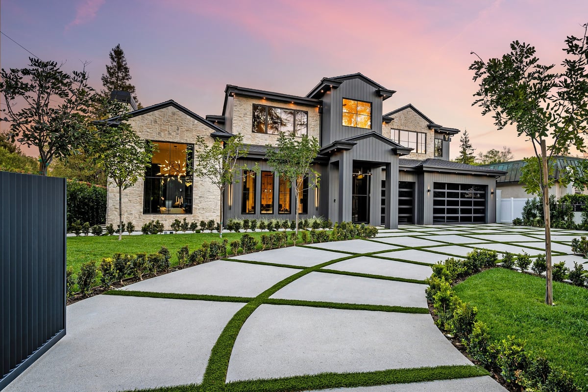 Modern luxury home exterior with a well-manicured lawn