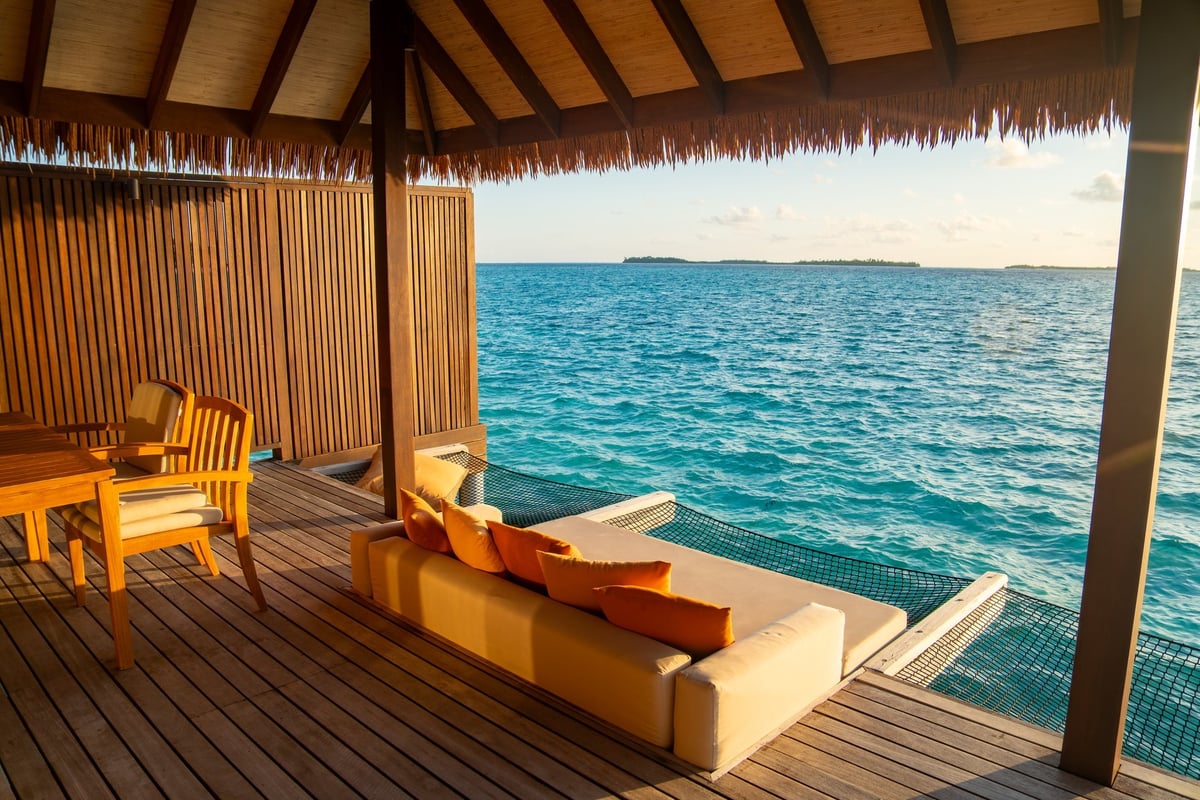Sunset views from overwater pool villa in Maldives. High quality photo