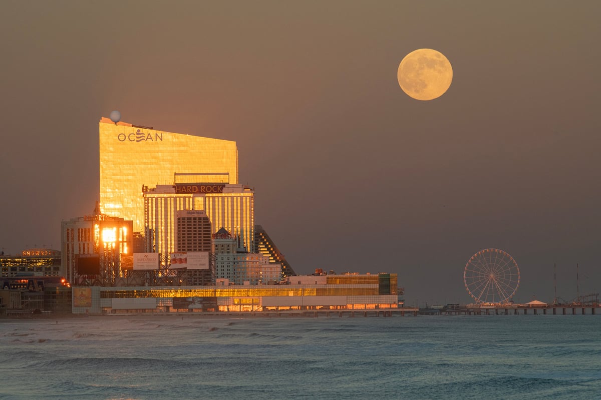 Afternoon view of the Atlantic City skyline with casinos illuminated by the setting sun