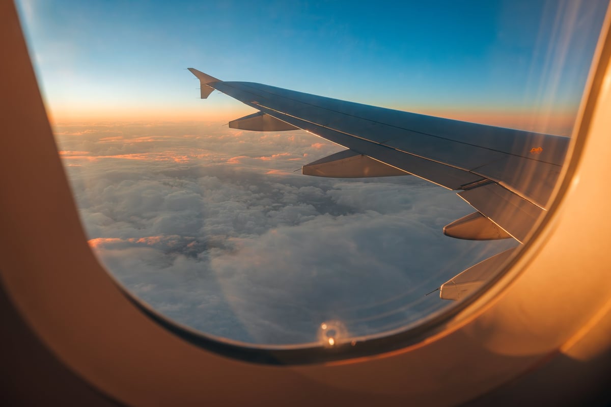 Aerial view of clouds and sunset from airplane window