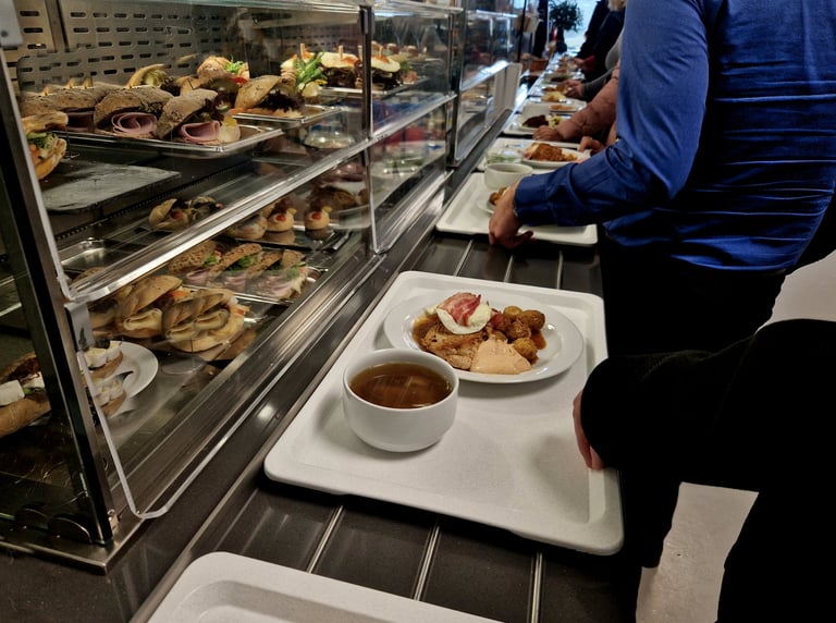 waiting in line with a tray is annoying. choose food and then slide the tray along the metal rails of the counter by the cooler, office factory , worker