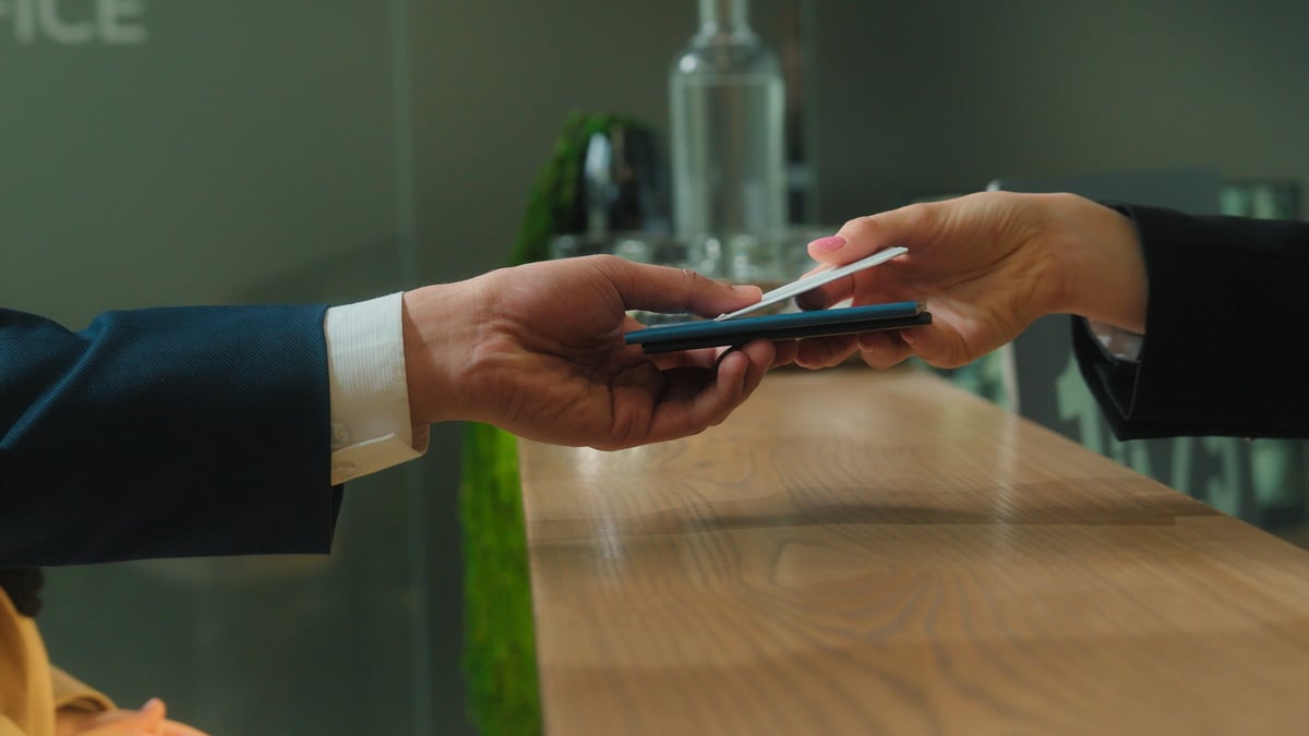 Close up hands give passports documents at hotel reception