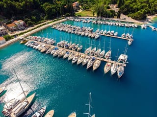Scenic aerial view yachts boats moored at bay harbor shore