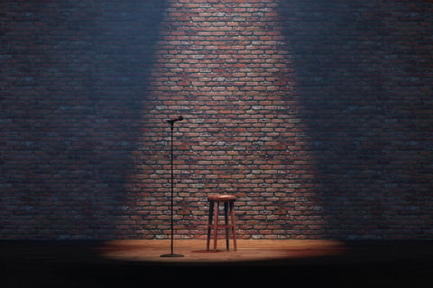 Empty stand-up stage with a microphone and bricks on background. 3d illustration