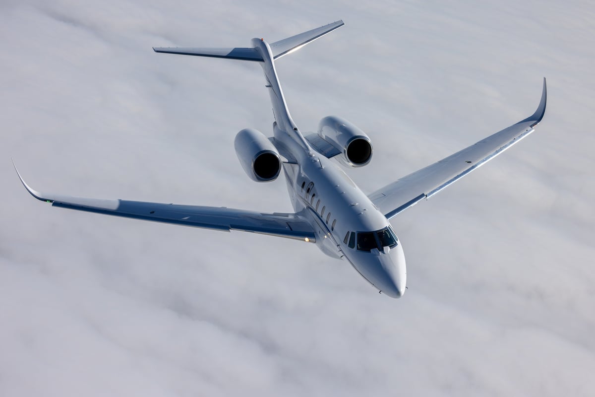 Top view of a Citation X business jet over cloud layers