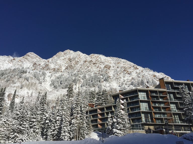 Winter mountain landscape with a snow-covered peak and modern resort in Snowbird, Utah