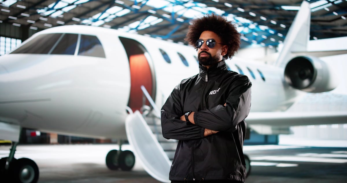 Confident African Security Guard Protecting VIP Celebrity at Private Jet