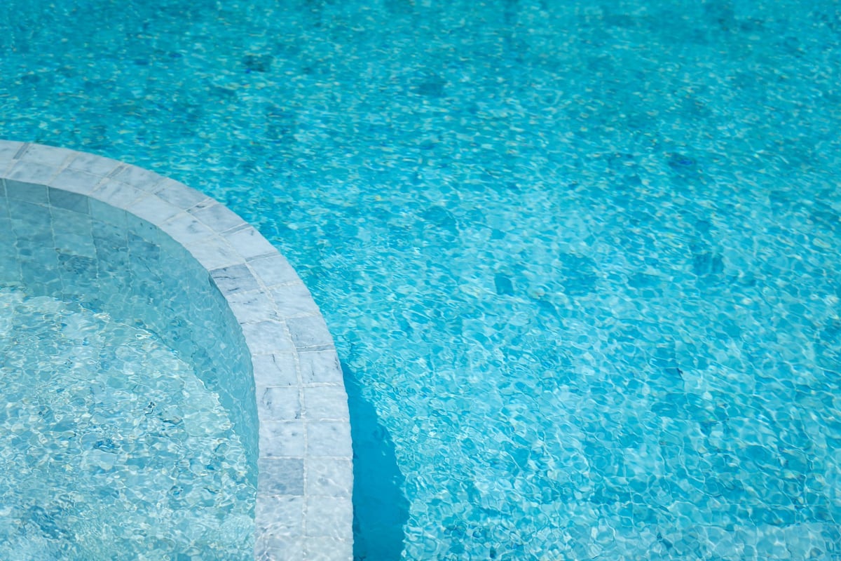 Luxury style swimming pool building with white marble floor and brightness blue water
