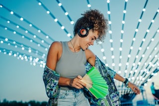 Young woman enjoying music festival with headphones
