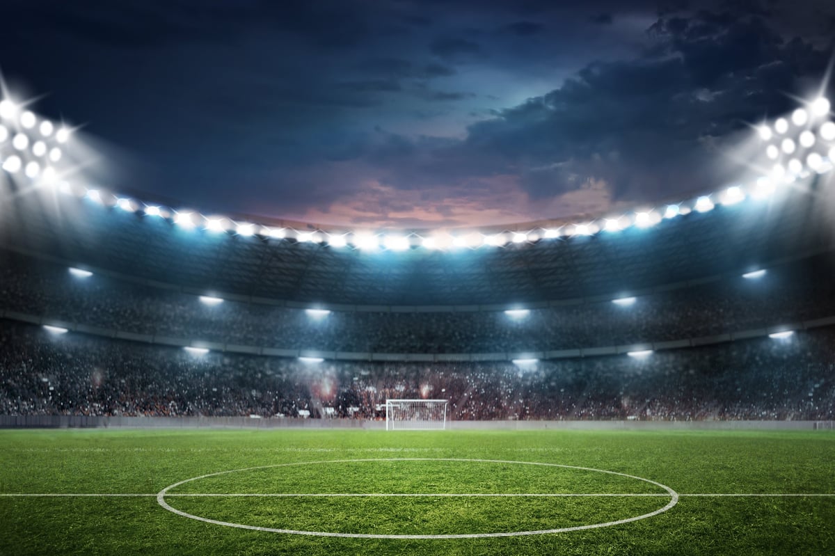 View of illustrated football ground at night with dramatic lighting