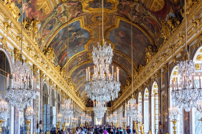 Hall of Mirrors at Versailles Palace with ornate golden architecture