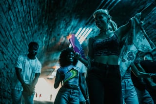 Group of friends going out of an underground rave party