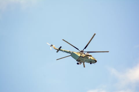 Helicopter flying with blue sky in the background