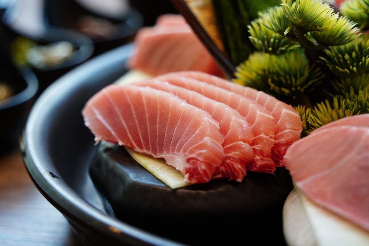 Close-up of Sliced Tuna Sashimi on Black Plate