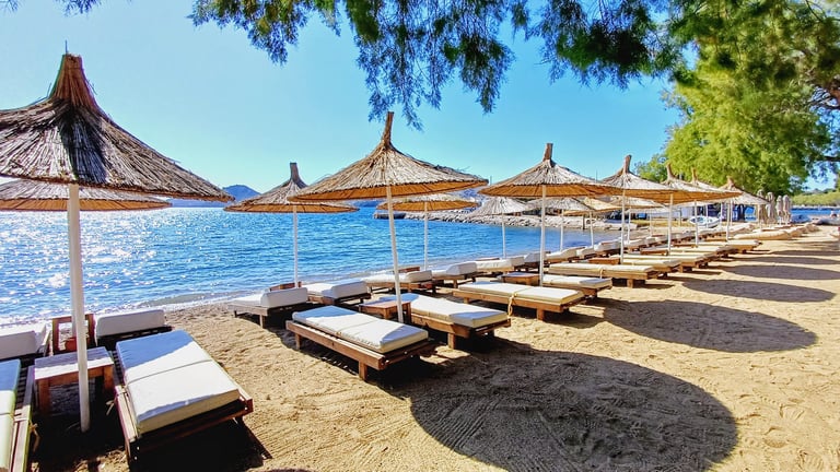 beach holiday seaside sun loungers umbrellas