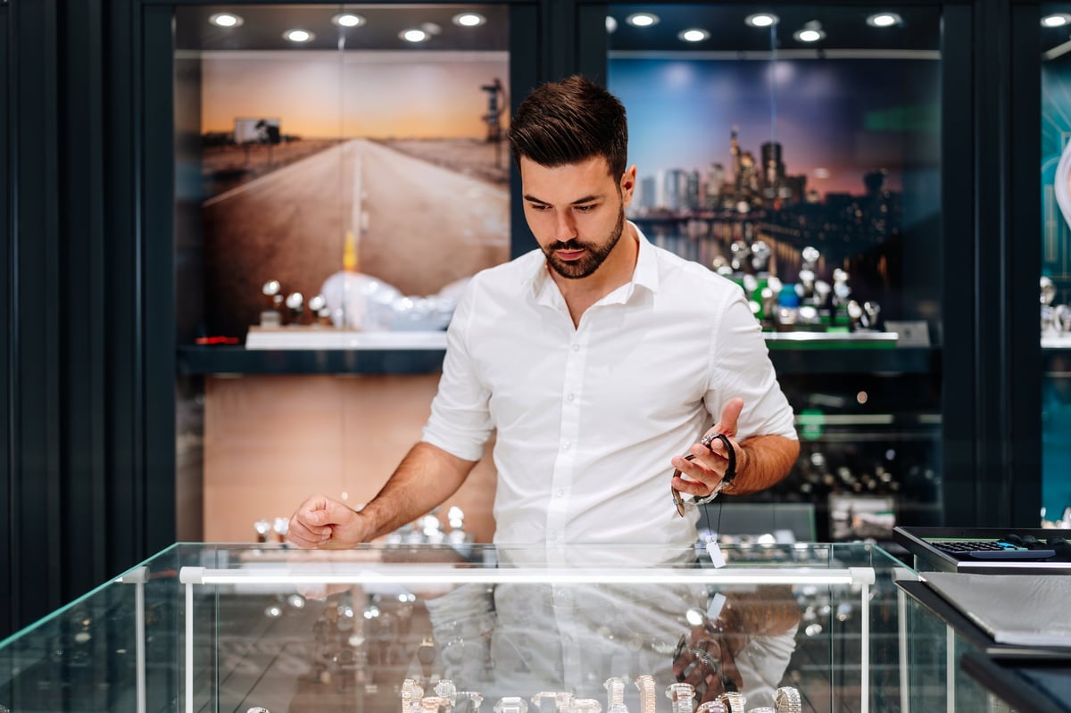 Young businessman choosing luxury watch in an expensive jewelry store
