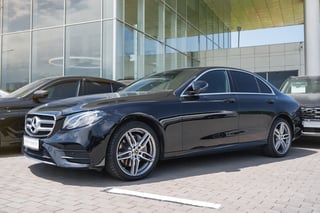Black Mercedes-Benz E-Class in a parking lot