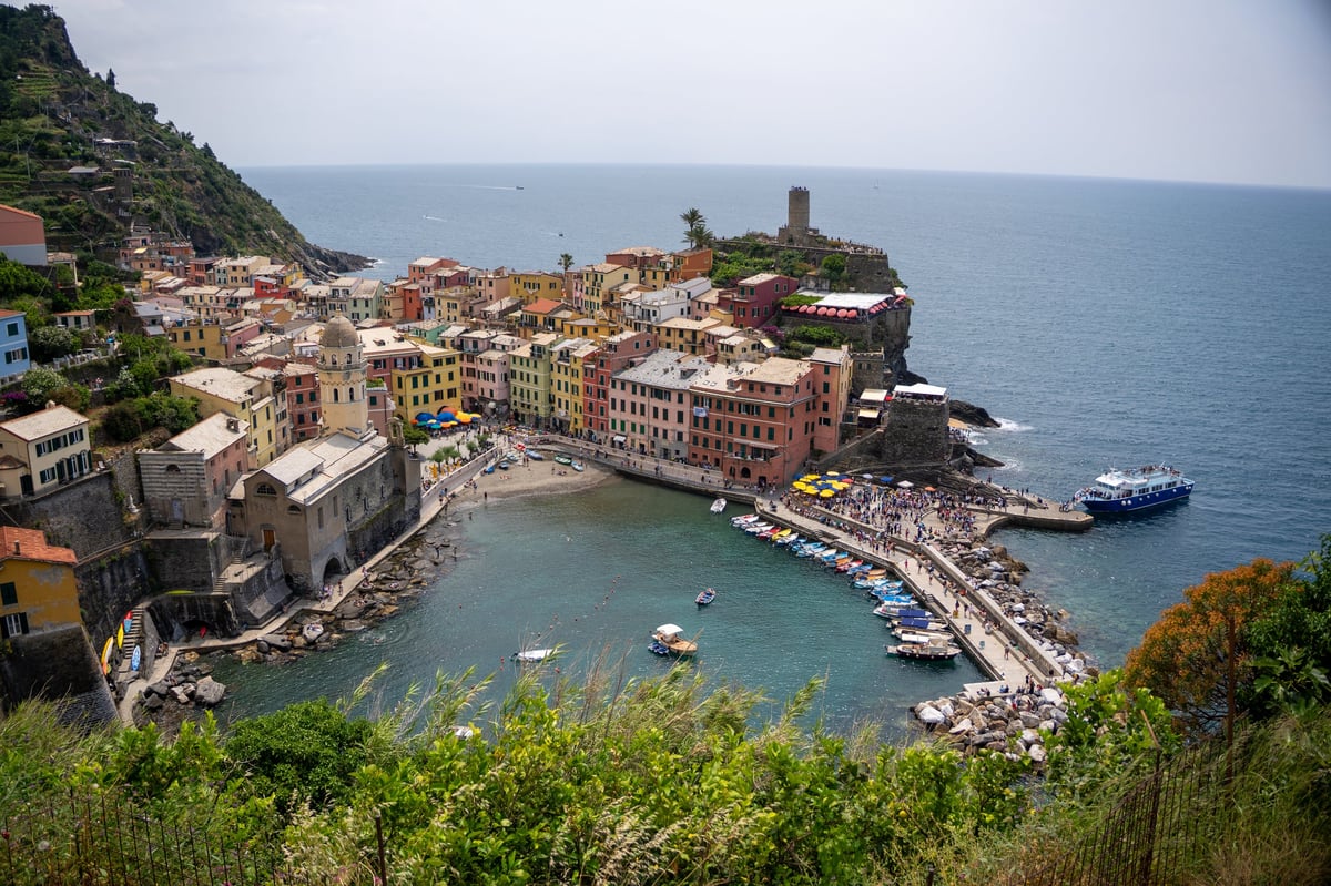 This scenic aerial view captures the vibrant colors and architecture of Vernazza, one of the five villages that make up the famous Cinque Terre region